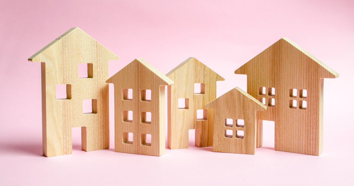 Photo of wooden houses, apartments and city buildings of different sizes